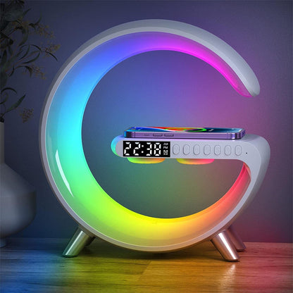 A colorful circular charger lamp with a digital display and multiple lighting bands, set on a wooden surface in a dimly lit room, displaying a time and app icons on the digital screen.